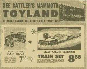 A vintage newspaper ad for Sattler's Mammoth Toyland, featuring sales for a dump truck for $7.88 and a train set for $8.88.