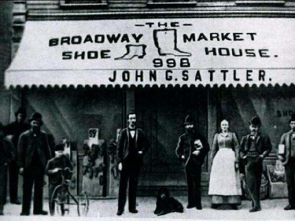 A historic black-and-white photo of a group standing in front of
