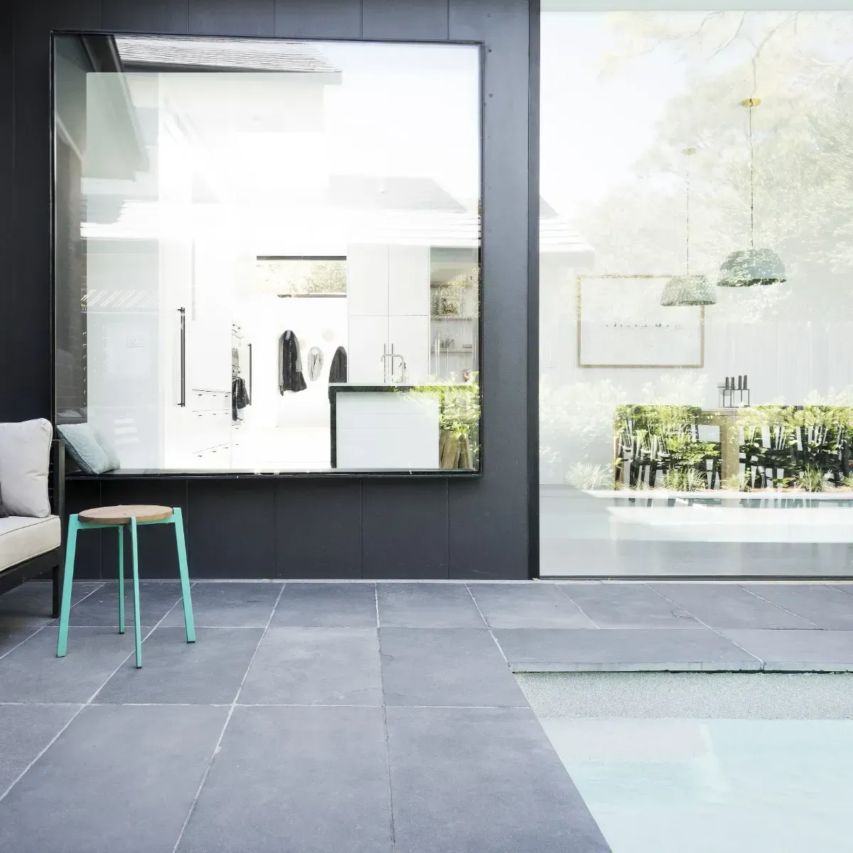 A Poolside Patio With Grey Marble Tiles And A Stool— Amber North Coast In Port Macquarie, NSW