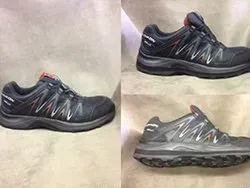 Three pairs of shoes are sitting on top of each other on a table.