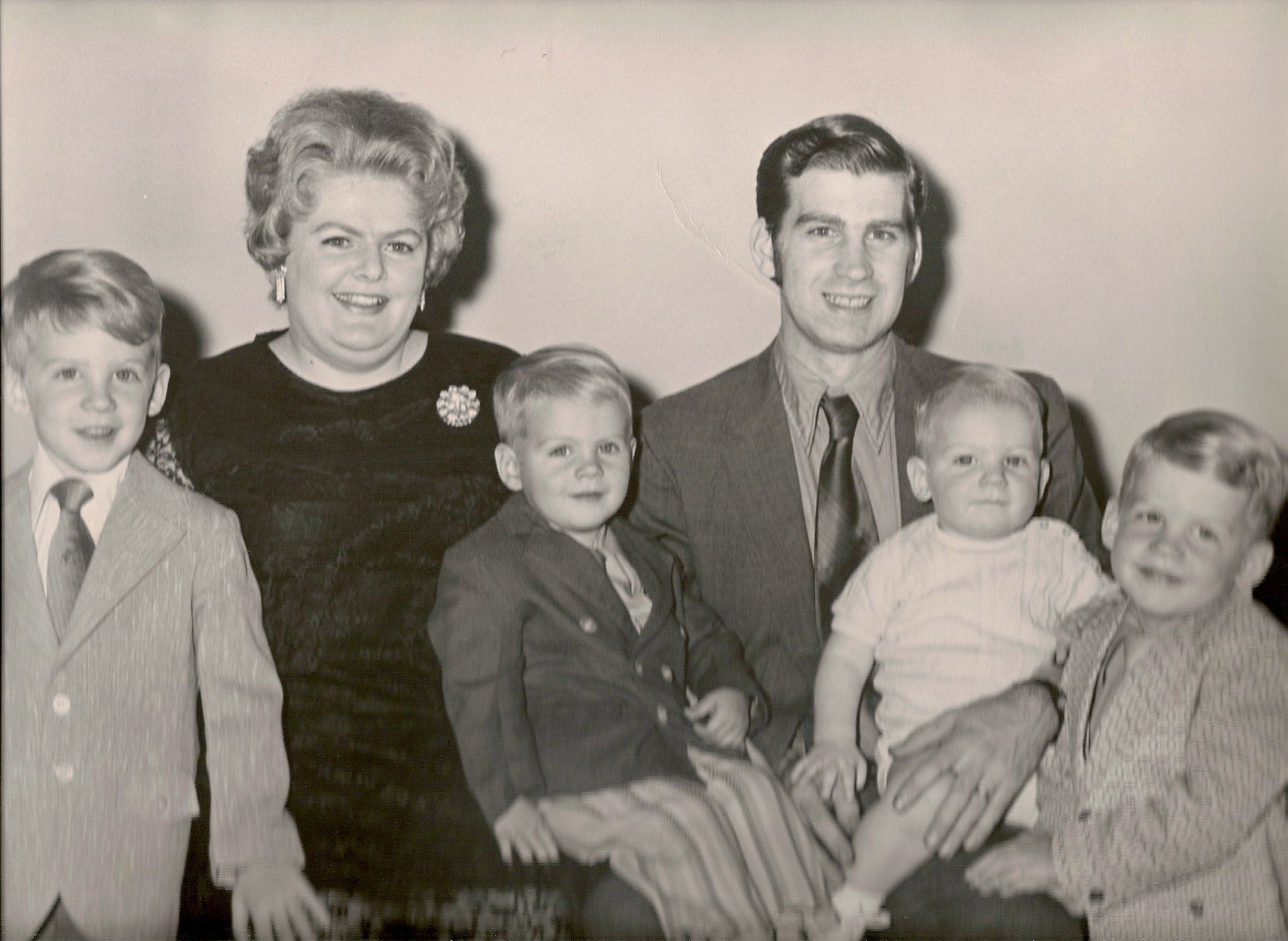 A black and white photo of a family posing for a picture