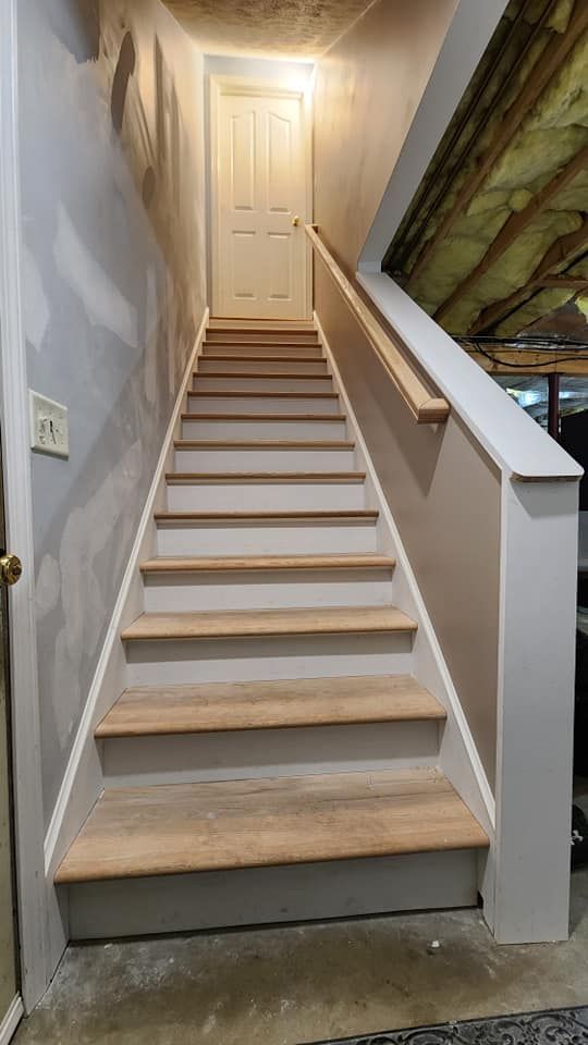 A set of stairs leading up to a door in a house.