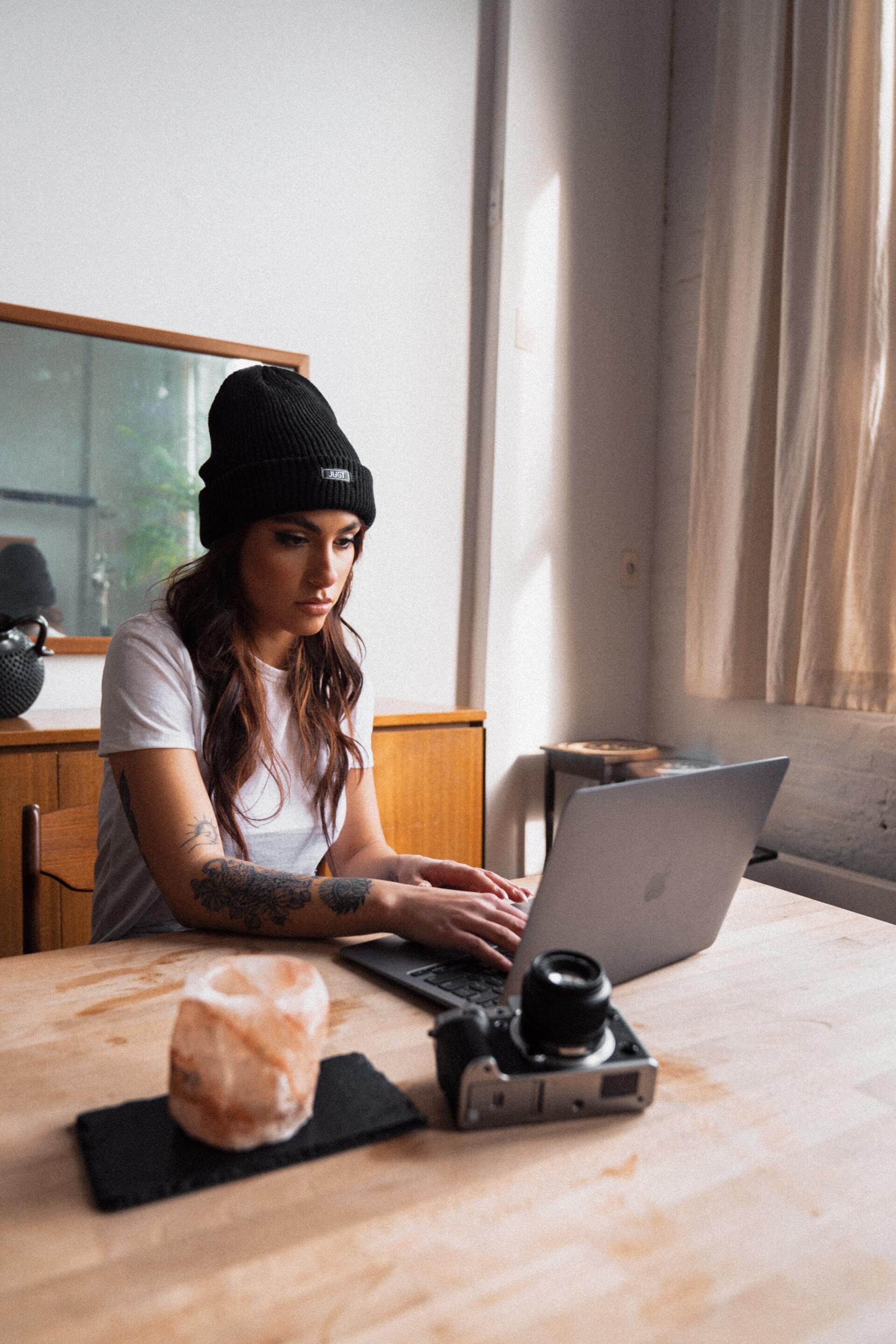 Student using her laptop while inside Zuma Housing apartment