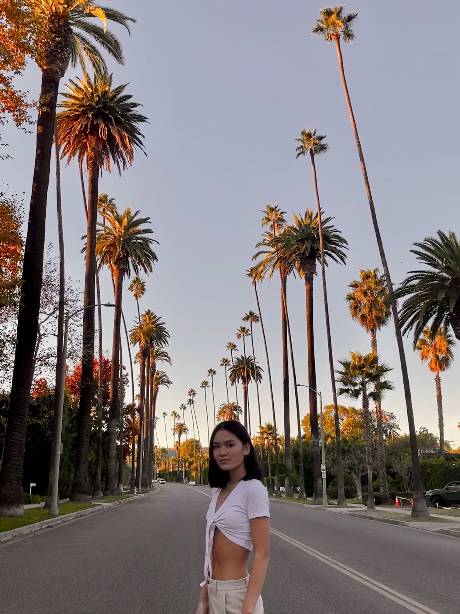 Jasmine Hu Zuma Housing tenant testimonial with palm trees in Los Angeles