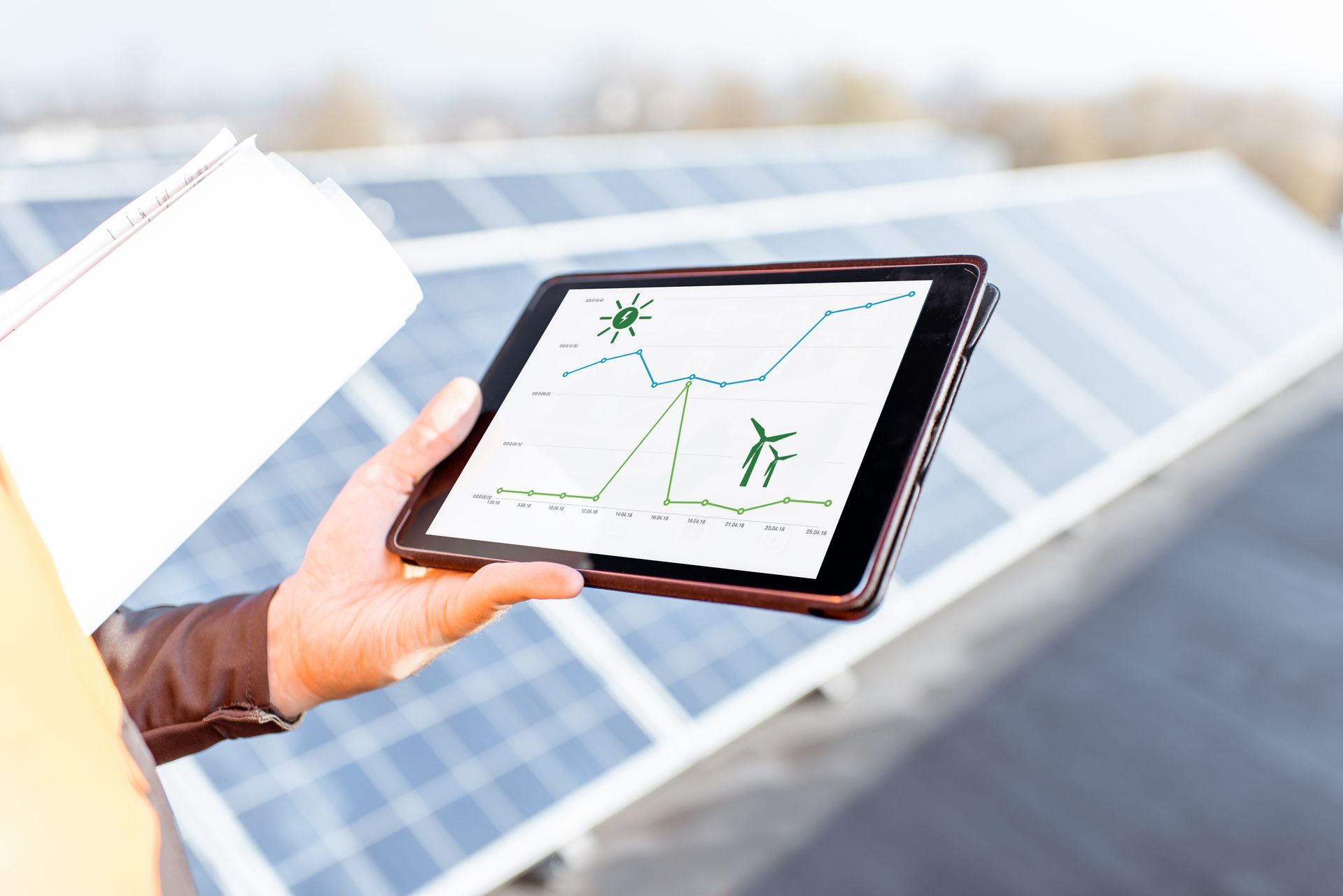 Solar panels on a rooftop, with a monitor displaying performance data Solar panels on a rooftop, with a monitor displaying performance data
