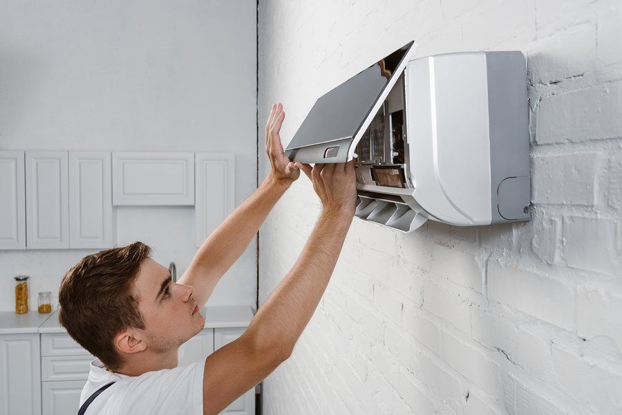 repairman checking the air conditioner