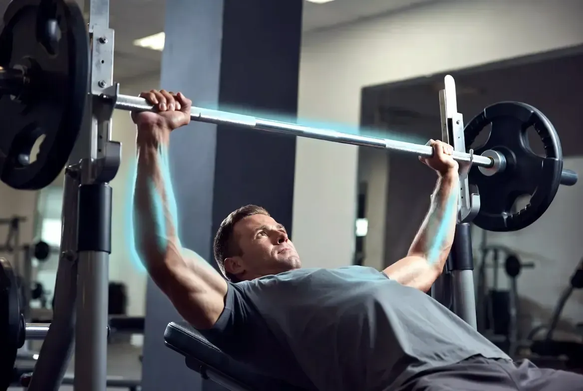 Athlete performing barbell bench press in a modern high-performance gym with subtle glowing effect h