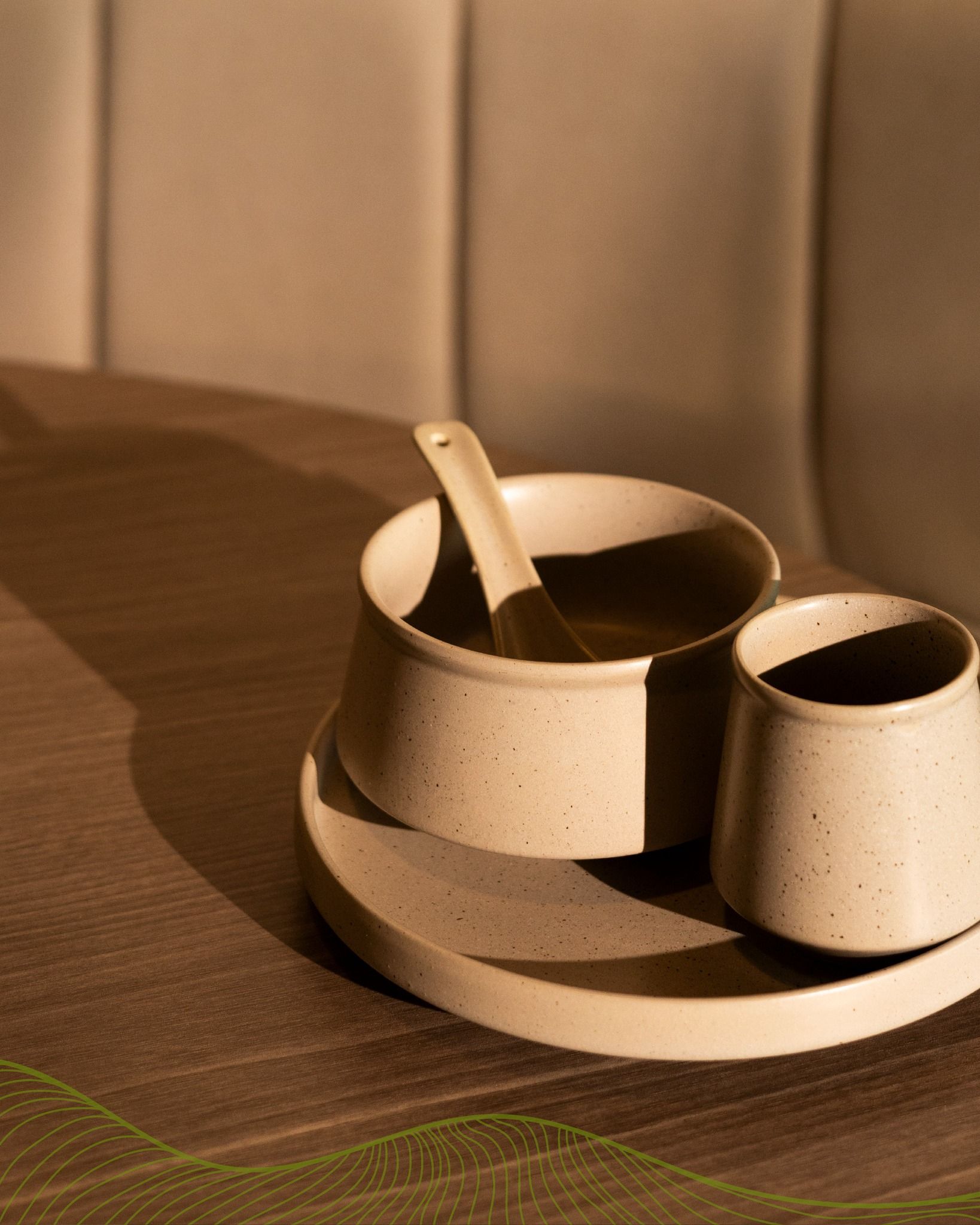 Cream ceramic cups and spoon on a wooden tray, lit by warm indoor light.