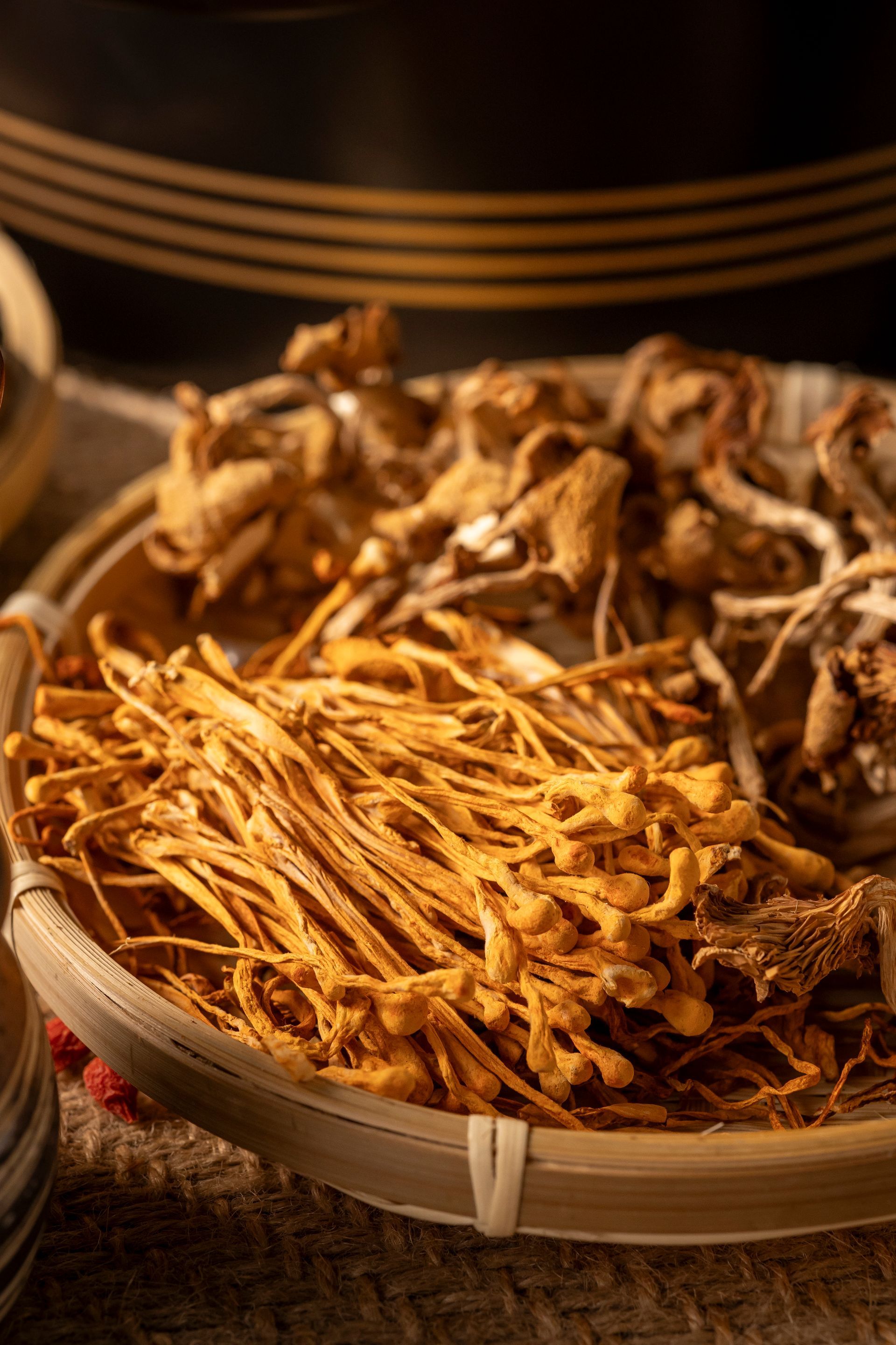 Basket of dried orange and brown roots or mushrooms at a market stall