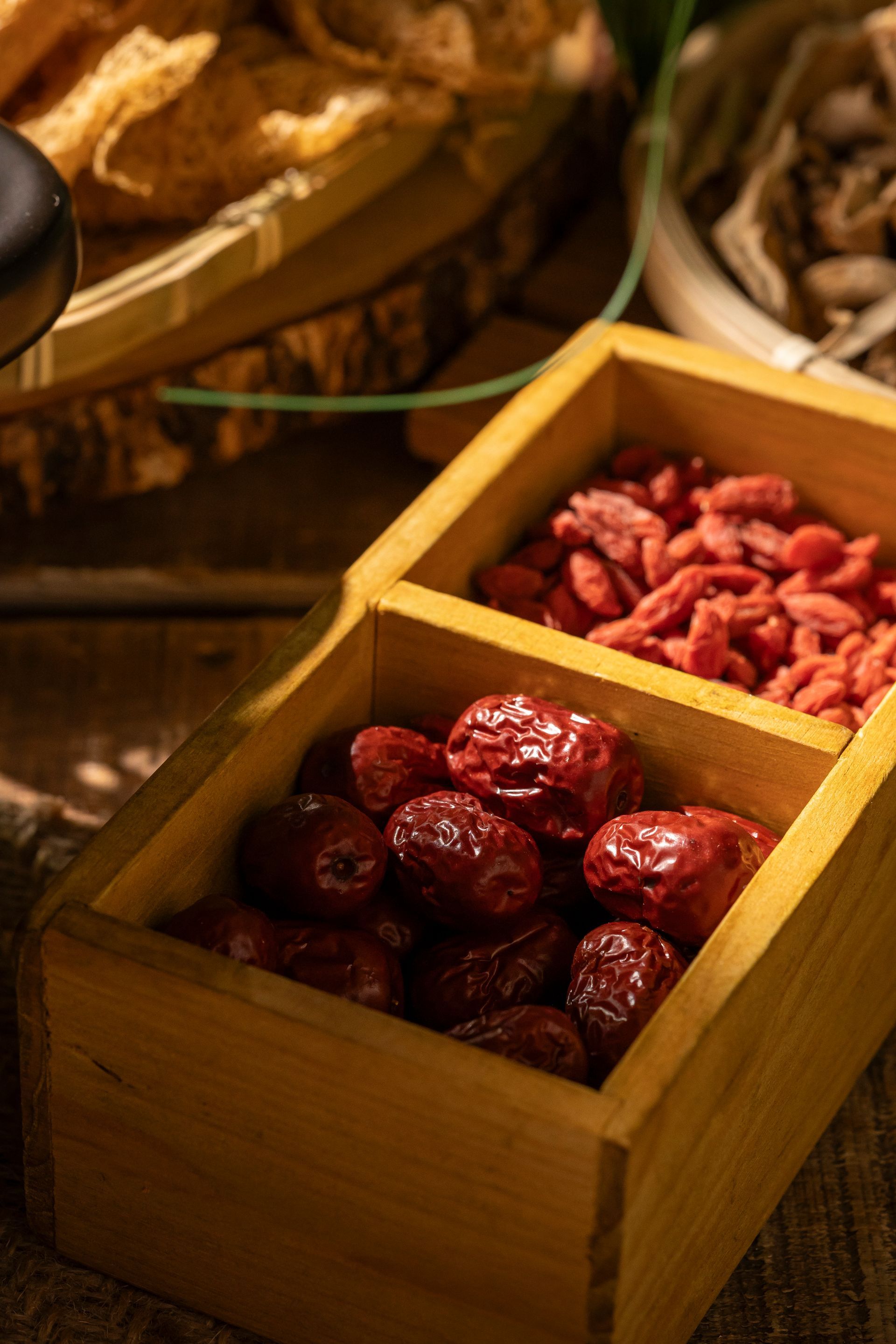 Wooden boxes of dried red fruit on a market display