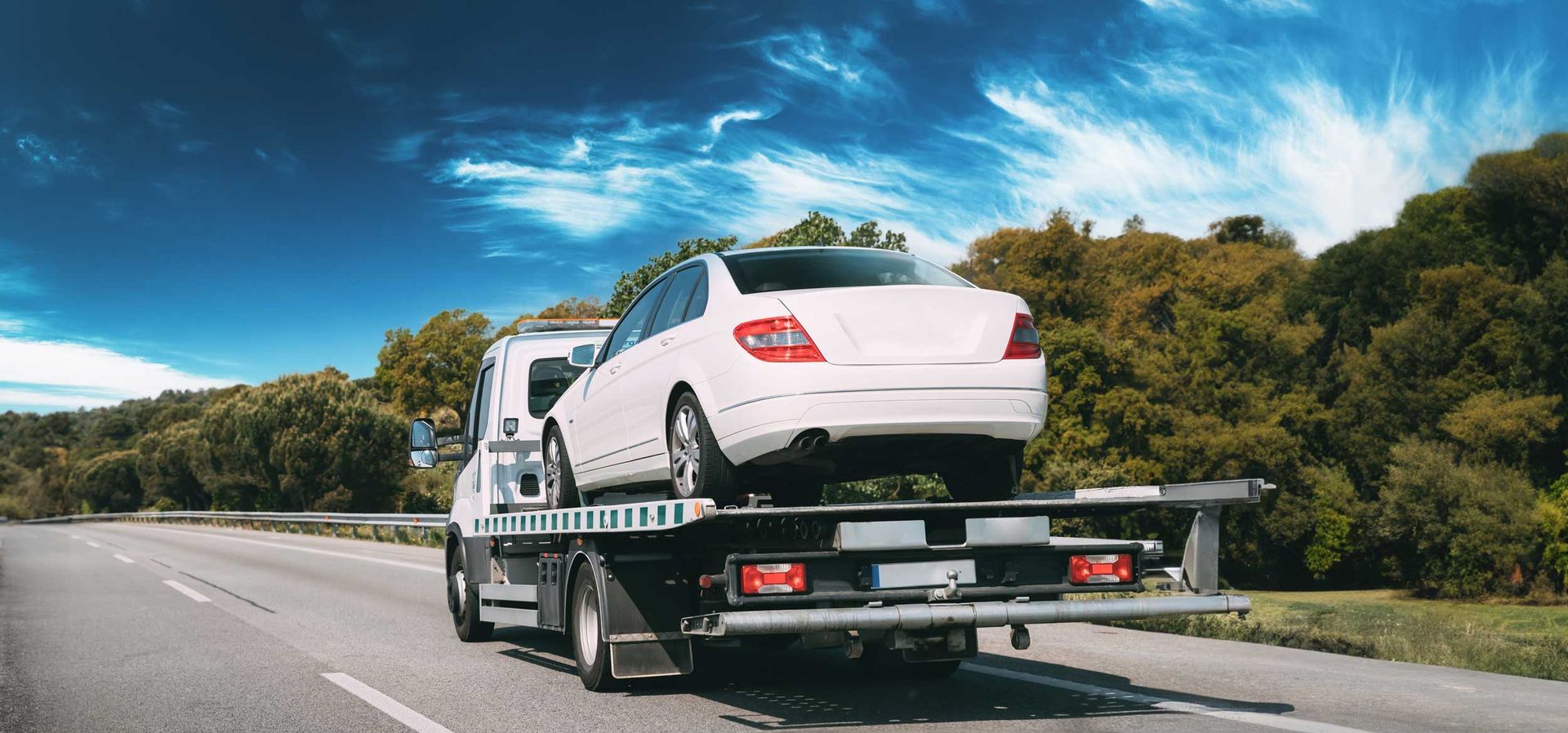 Tow truck transporting car or help on road transports wrecker broken car. 