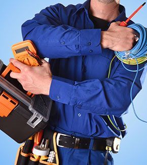 Background with uniformed electrician with tools and electrical equipment and blue background