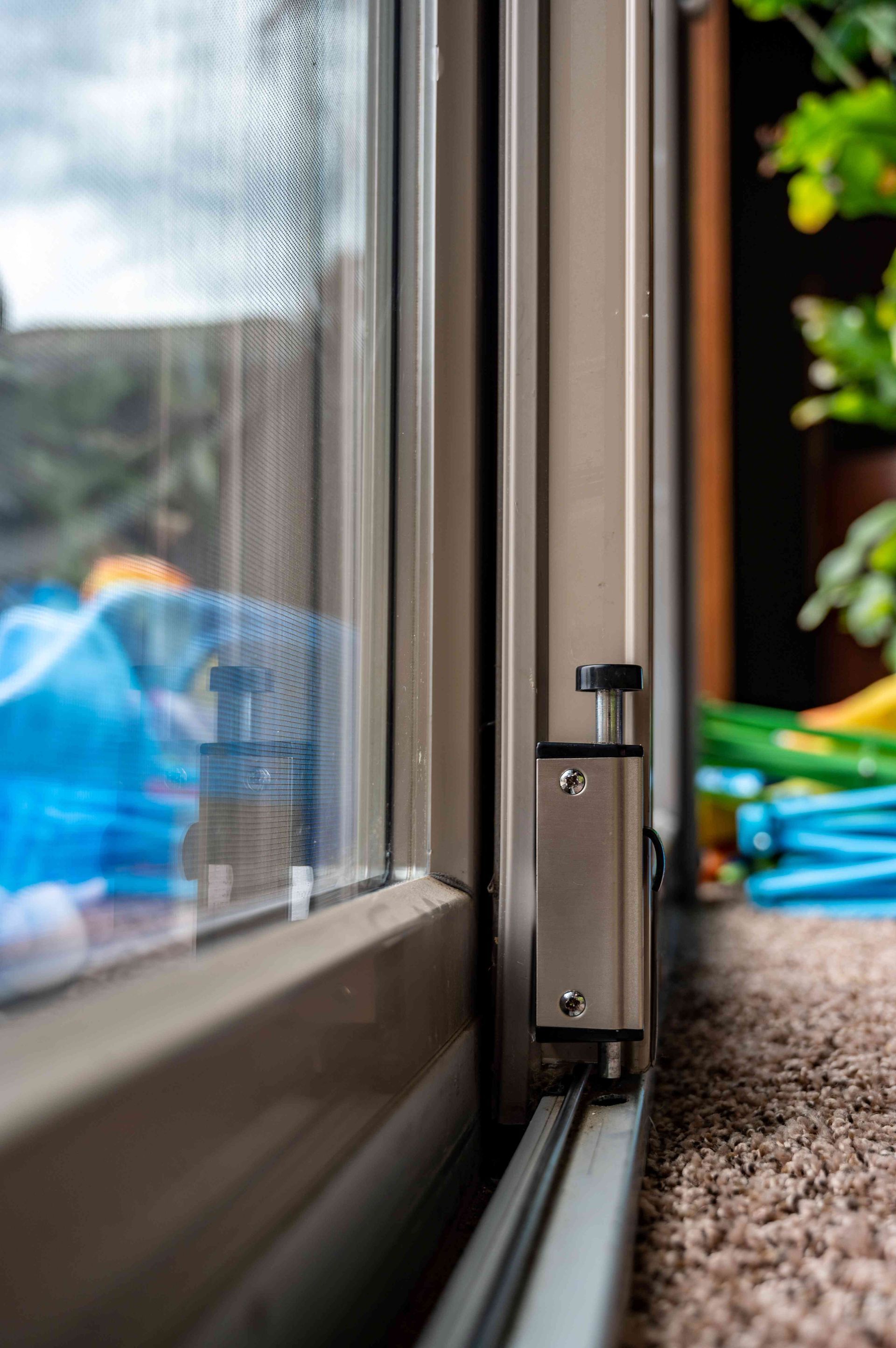 Storm window installation on a home's exterior window frame.