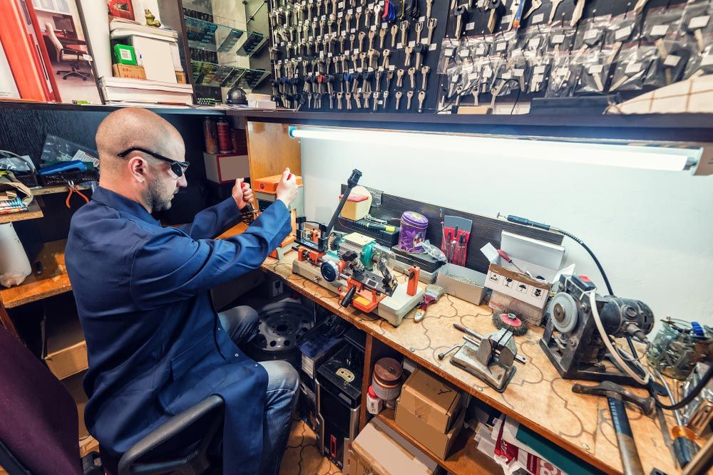 Locksmith In Workshop Making New Key — Locksmith In Bendigo, VIC Locksmith In Workshop Making New Key — Locksmith In Bendigo, VIC