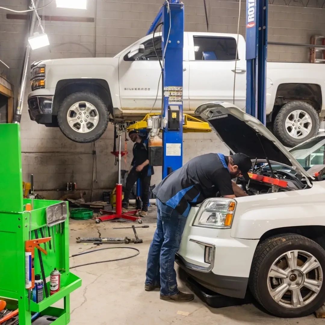 A Mechanic Is Looking Under the Hood of a Truck in a Garage | Professional Auto Repair