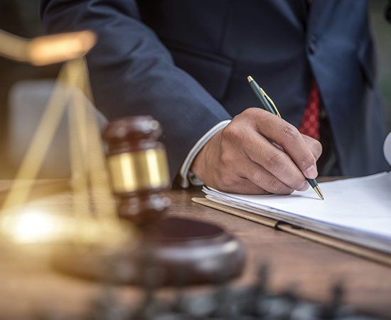 Gavel And Lawyer Writing — Eau Claire, WI — Law Offices Of Jeffrey Klemp LLC