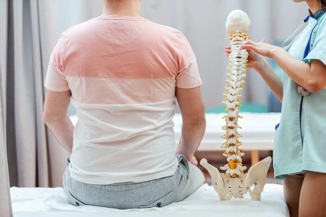 Doctor Holding Spine Model - Alexandria, Louisiana - Alexandria Spine & Rehab Center