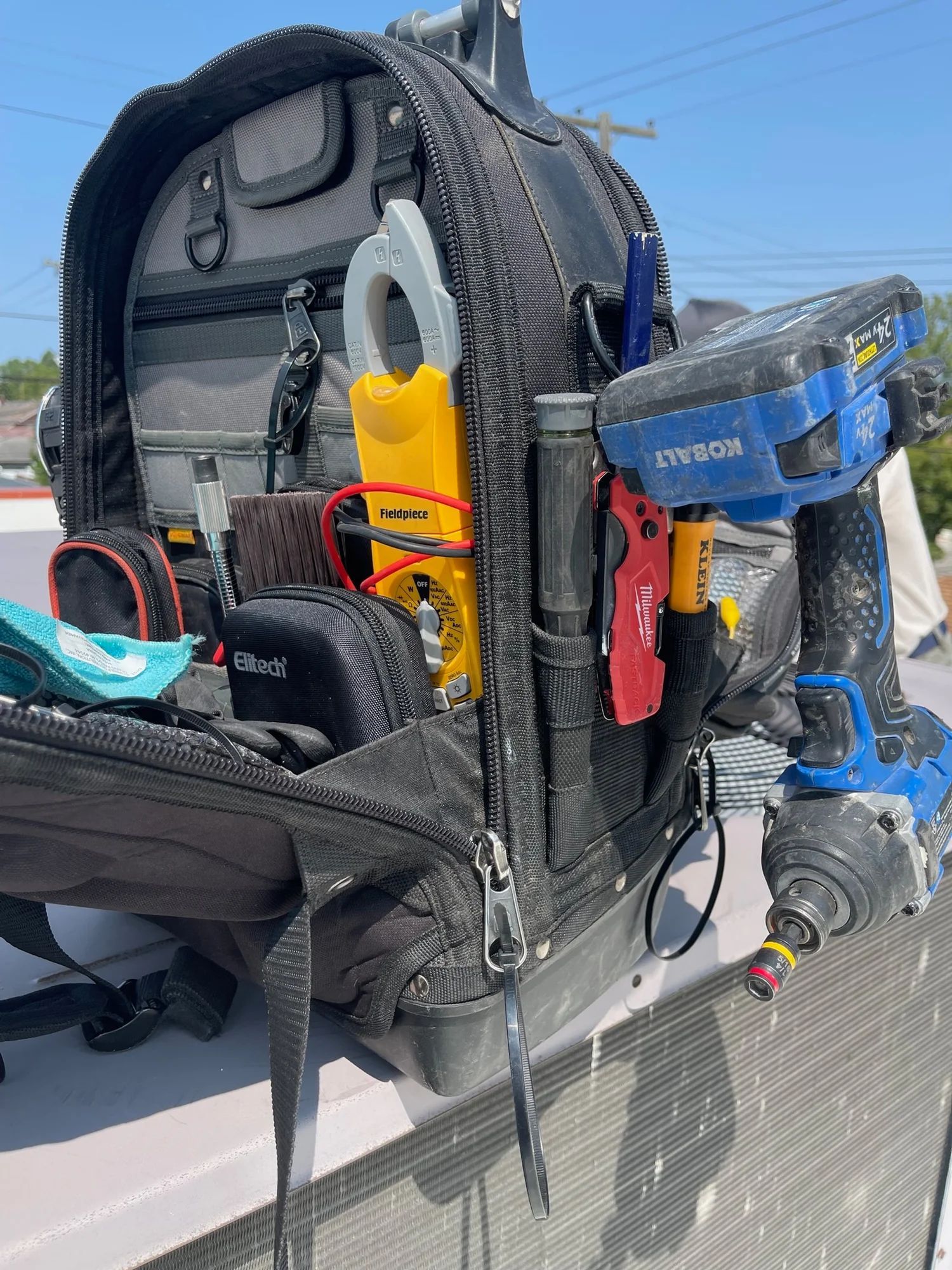 Open scuba gear on a boat deck, with mask, fins, regulator, and yellow safety device.