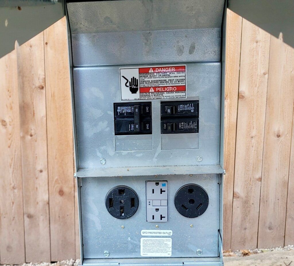 RV electrical hookup box with 30 amp and 50 amp connections.