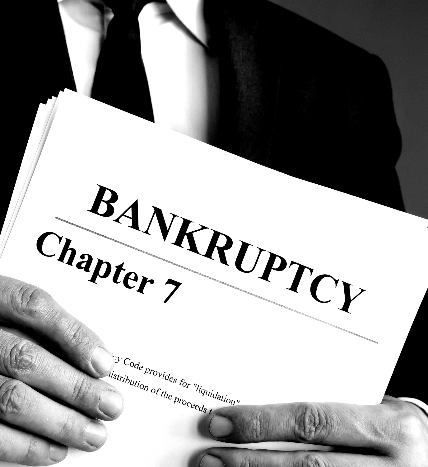 A man is holding a book titled bankruptcy chapter 7. A man is holding a book titled bankruptcy chapter 7.