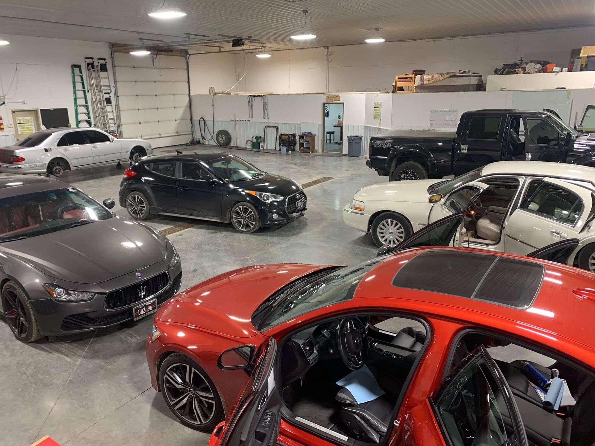 A lot of cars are parked in a garage.