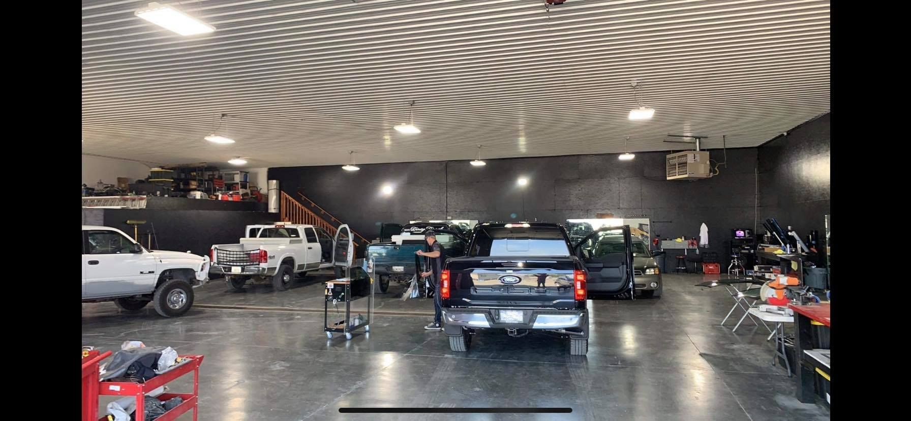 A lot of cars are parked in a garage.