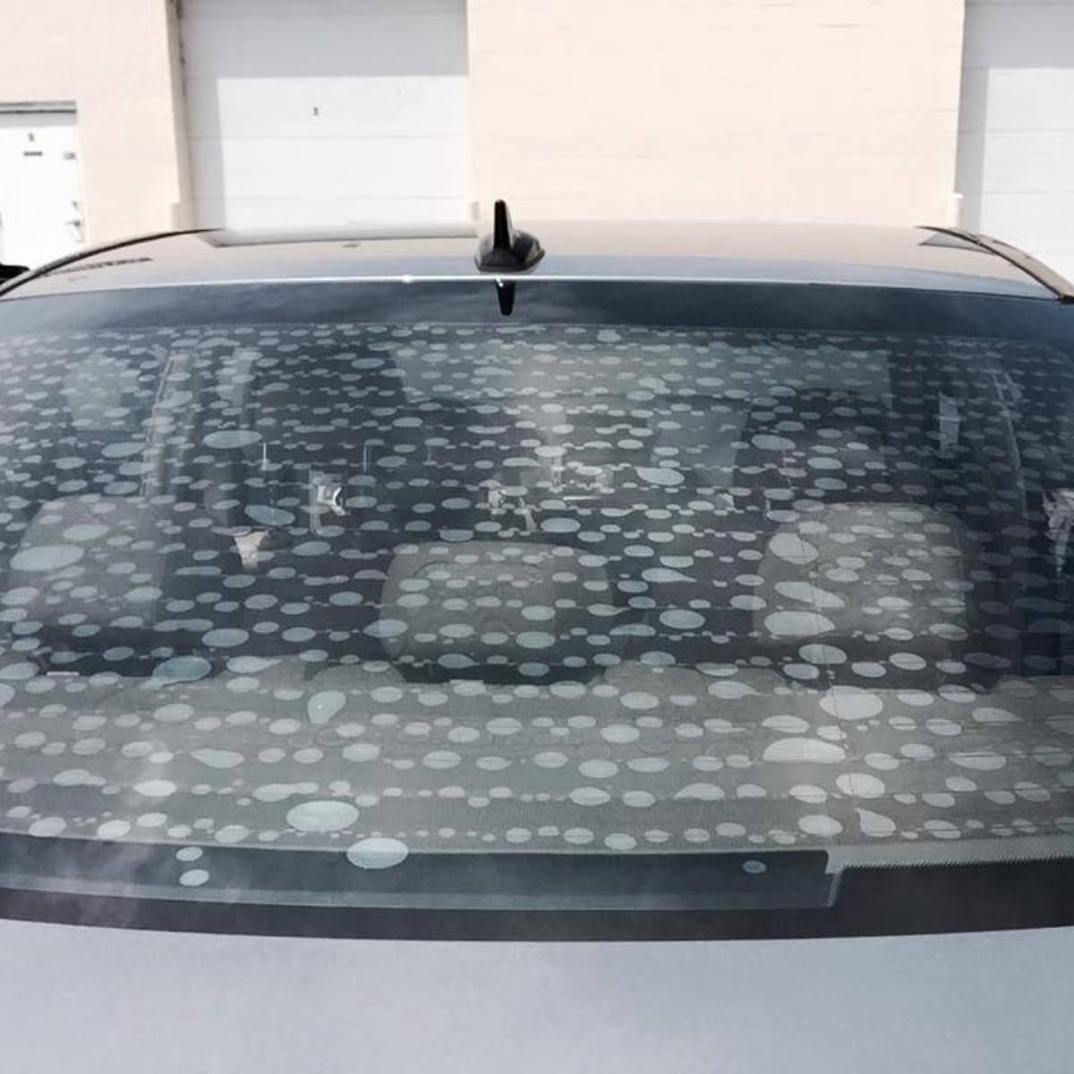 A car windshield with a lot of spots on it