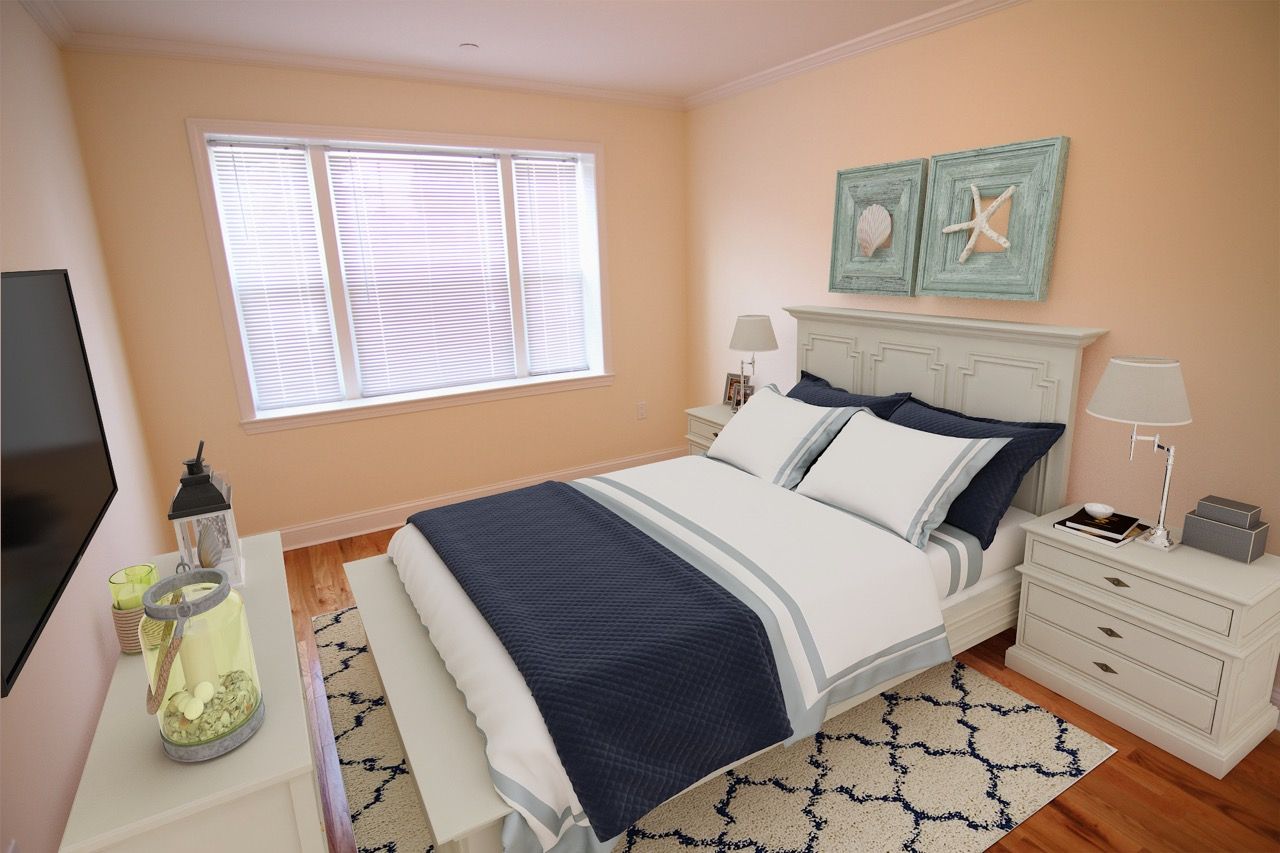 Bedroom with white furniture, navy and white bedding, and a large window with blinds.