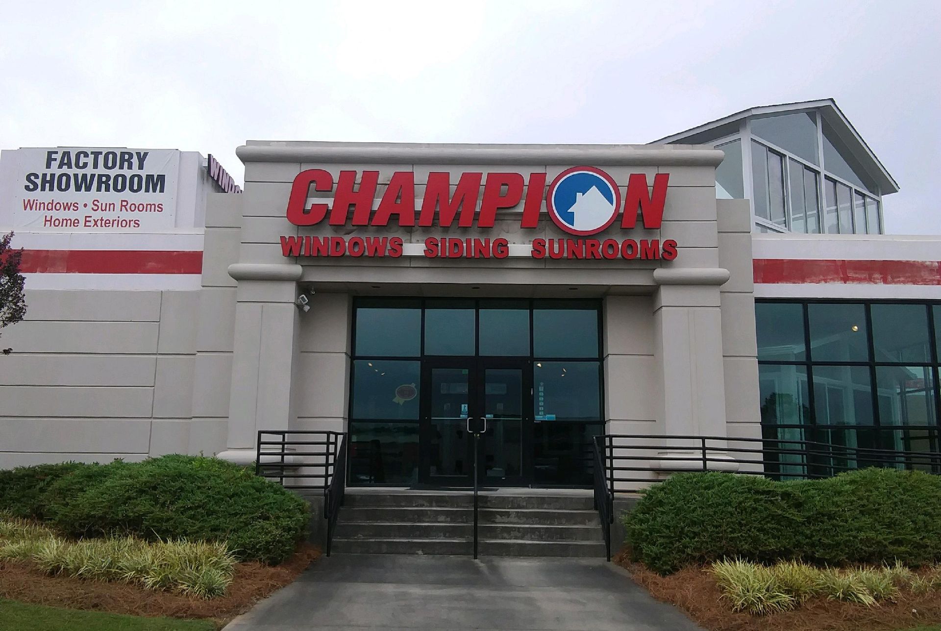 Champion Windows store exterior with red sign and glass doors.