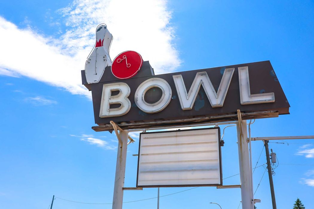 View of a commercial sign representing a bowling centre with a giant bawling ball and pin.