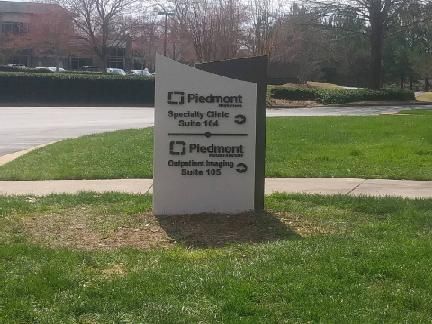 Piedmont sign in a grassy area. Specialty Clinic and Piedmont Imaging directions.