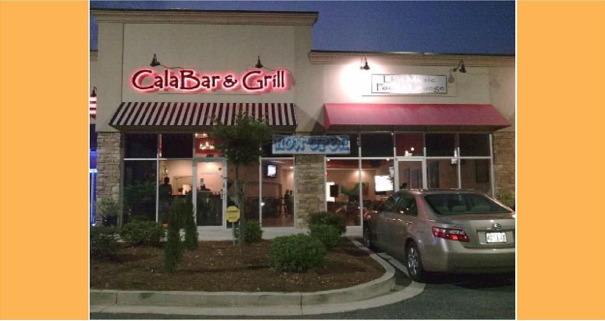 Cali Bar & Grill with red neon sign, next to another business. Beige car parked outside.