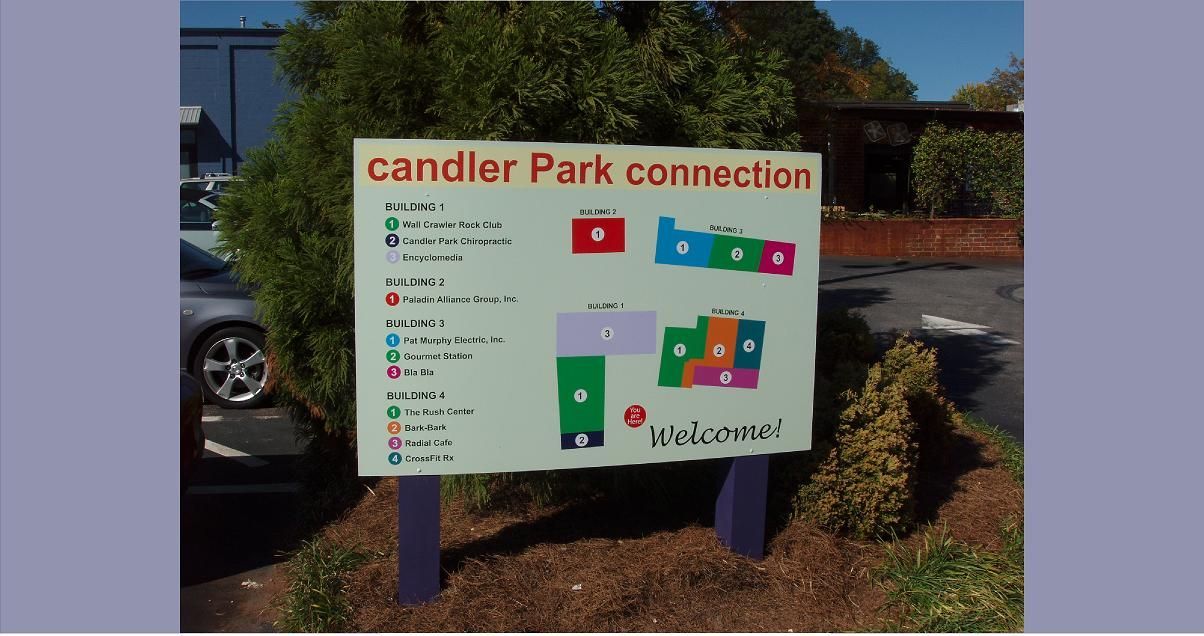 Candler Park Connection sign with a map. Purple and green colors. Outdoors, sunny day.