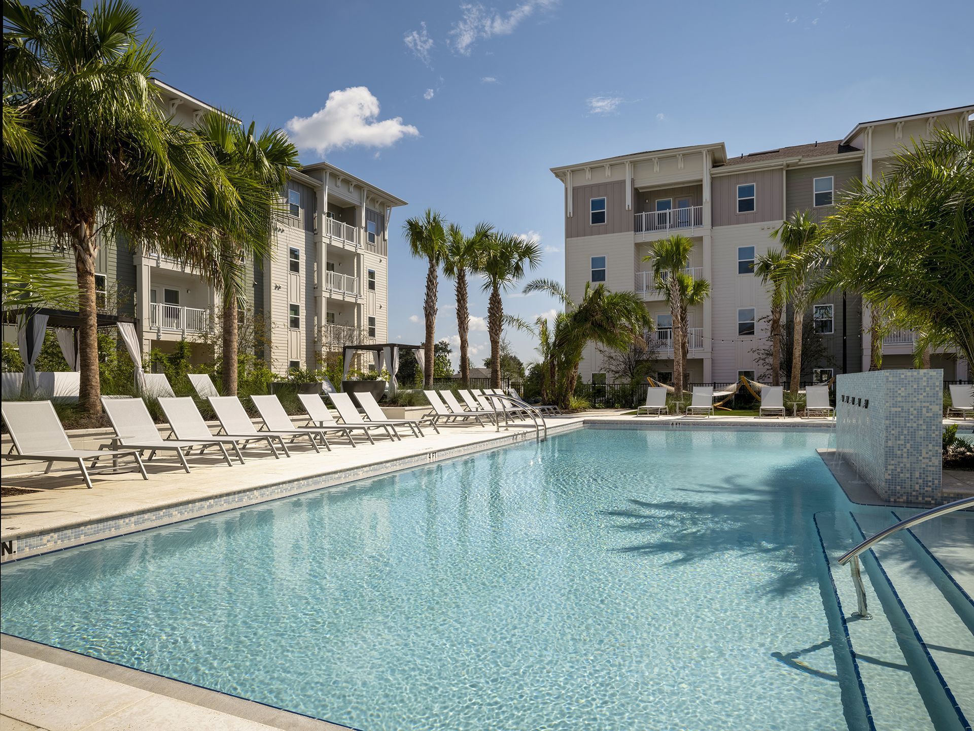 Palm trees around the pool at Livano Wildwood.