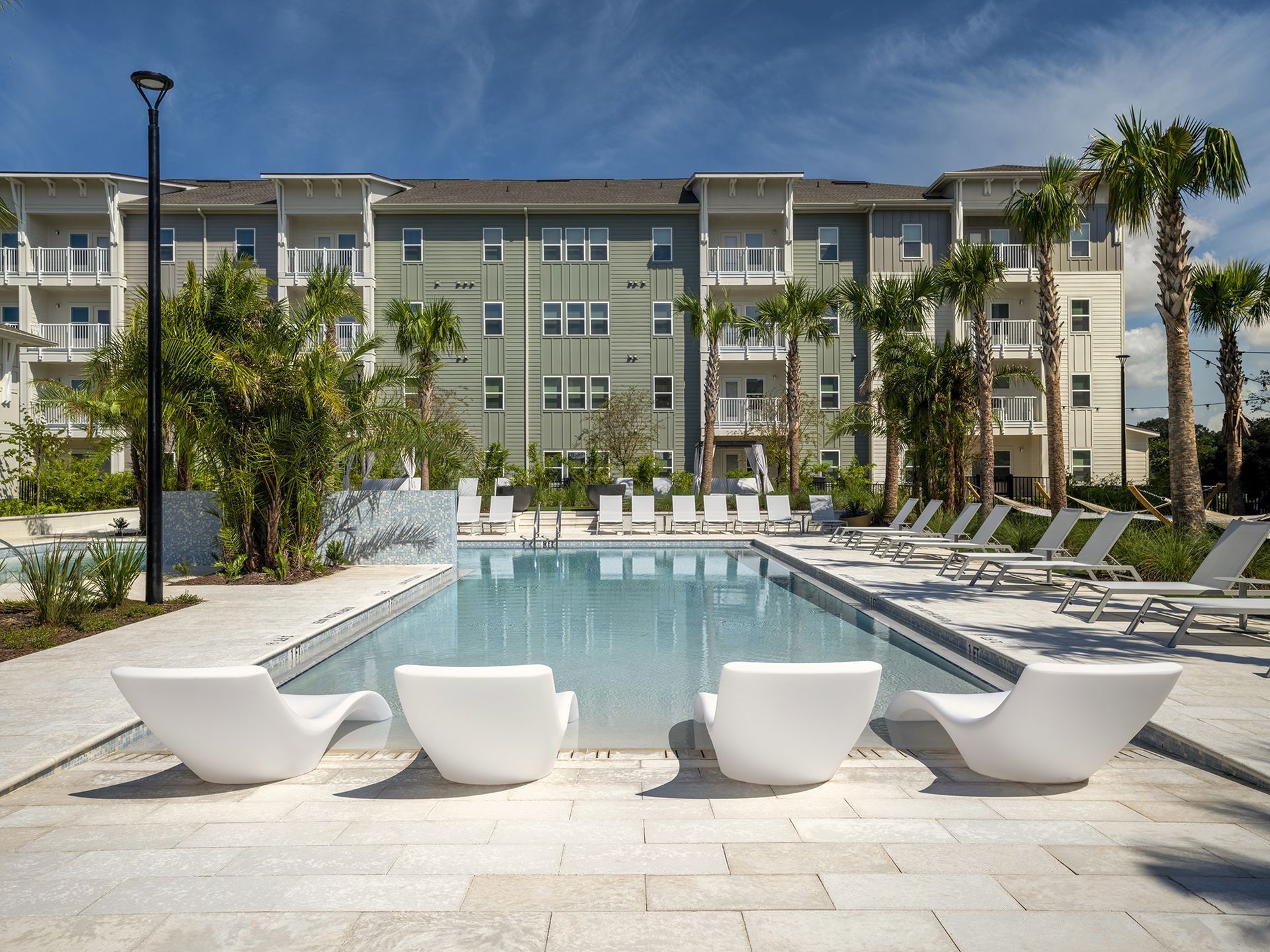 Lounge chairs on the sundeck of the swimming pool at Livano Wildwood.