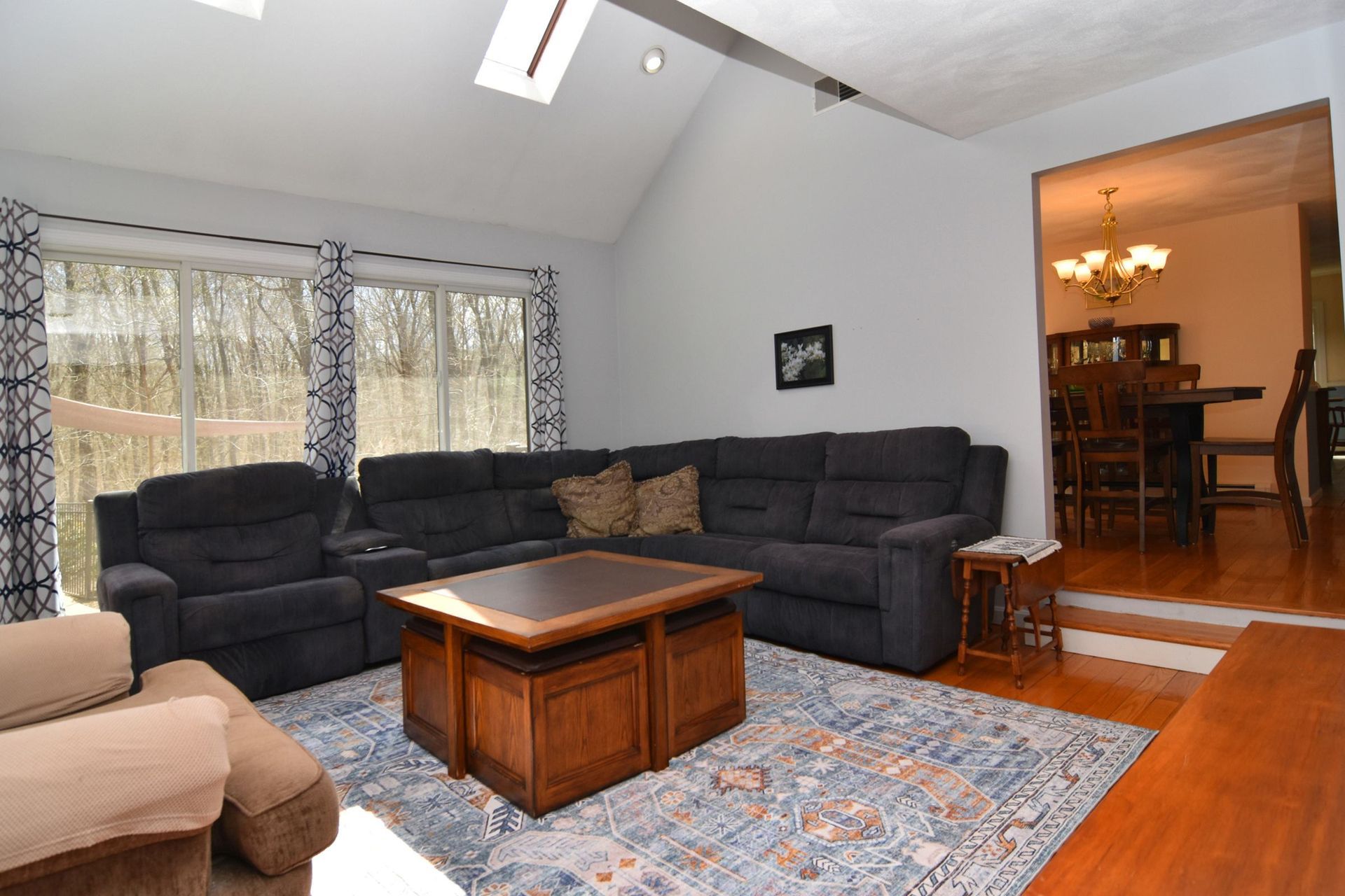 A living room with a large sectional couch and a coffee table