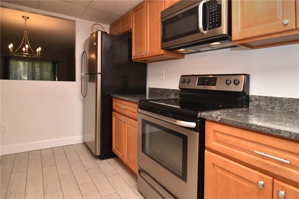 A kitchen with stainless steel appliances and wooden cabinets