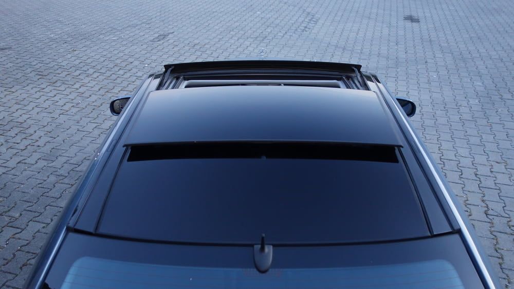 A Black Car With A Sunroof Is Parked On A Brick Pavement — Warren Ridge Auto Centre In Berkeley Vale, NSW