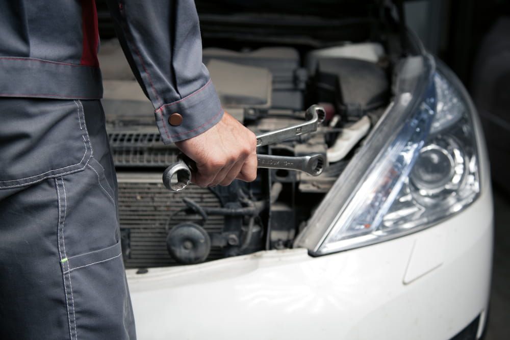 A Mechanic Is Working On A Car With The Hood Open — Warren Ridge Auto Centre In Berkeley Vale, NSW