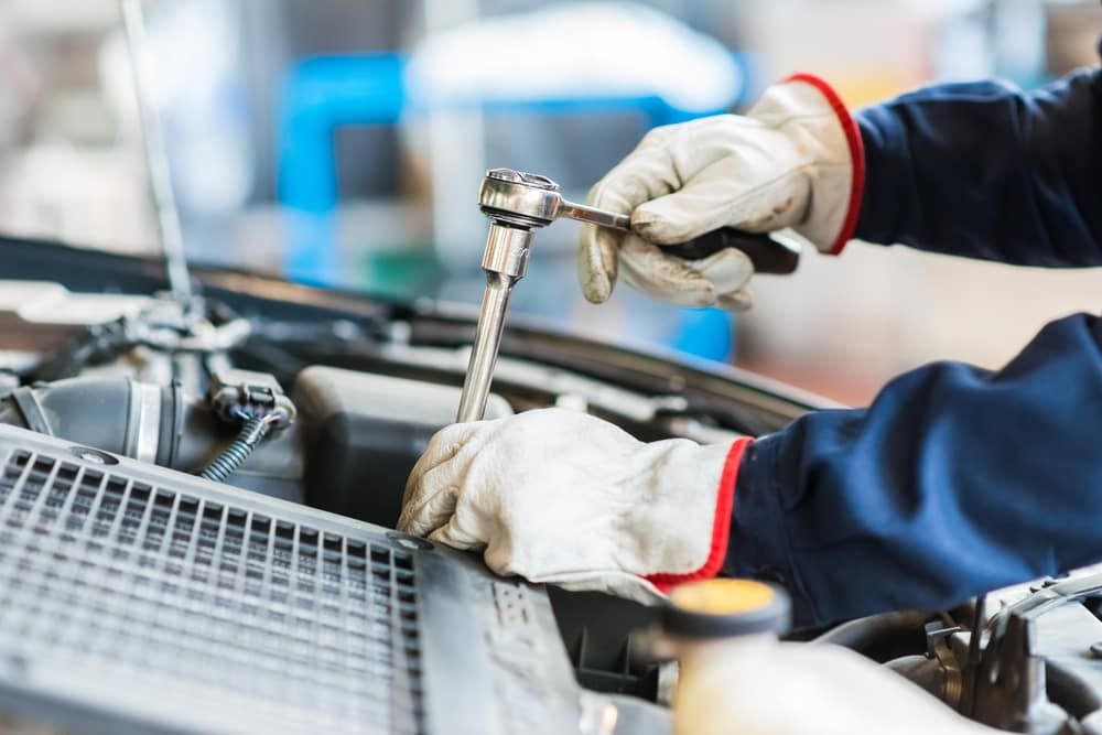 A Mechanic Is Working On A Car With A Wrench — Warren Ridge Auto Centre In Berkeley Vale, NSW