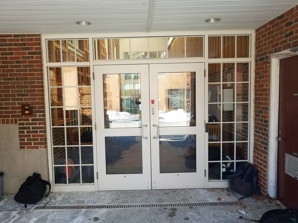A brick building with a large glass door