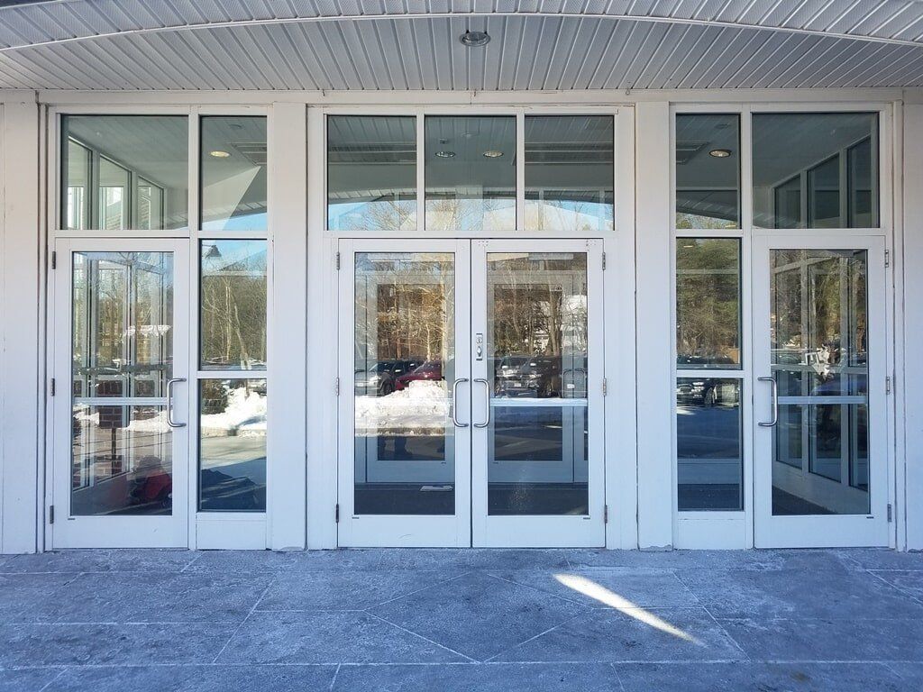 A building with a lot of glass doors and windows