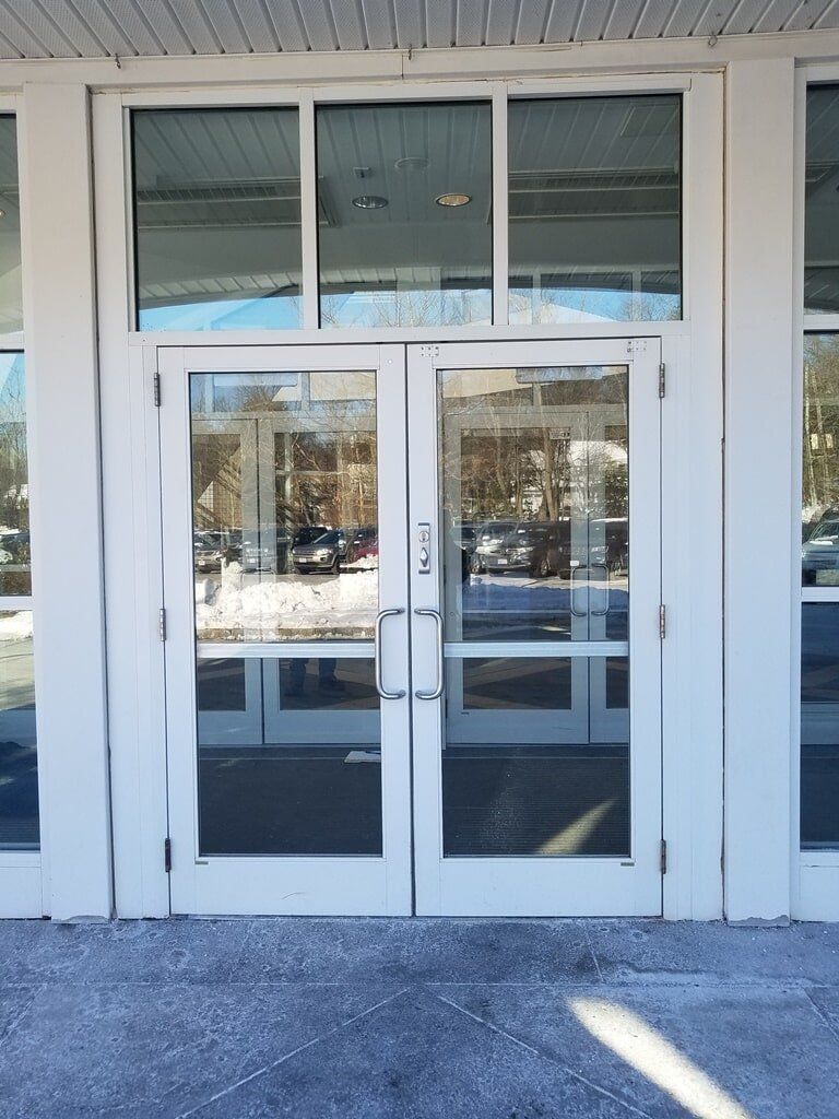 A white building with a lot of windows and doors