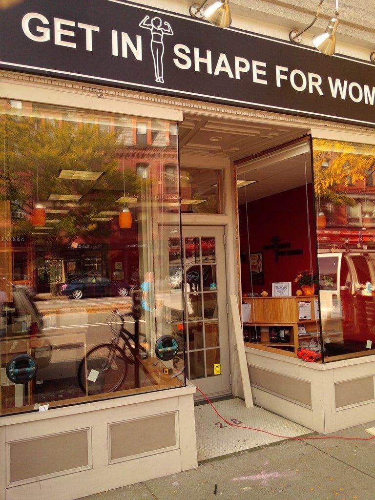 A store front with a sign that says get in shape for work