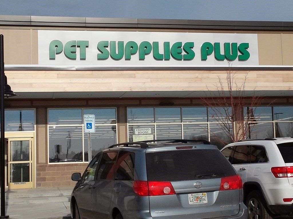 A car is parked in front of a pet supplies plus store