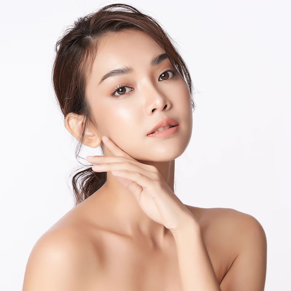 Portrait of a person with a hand near the face against a white background