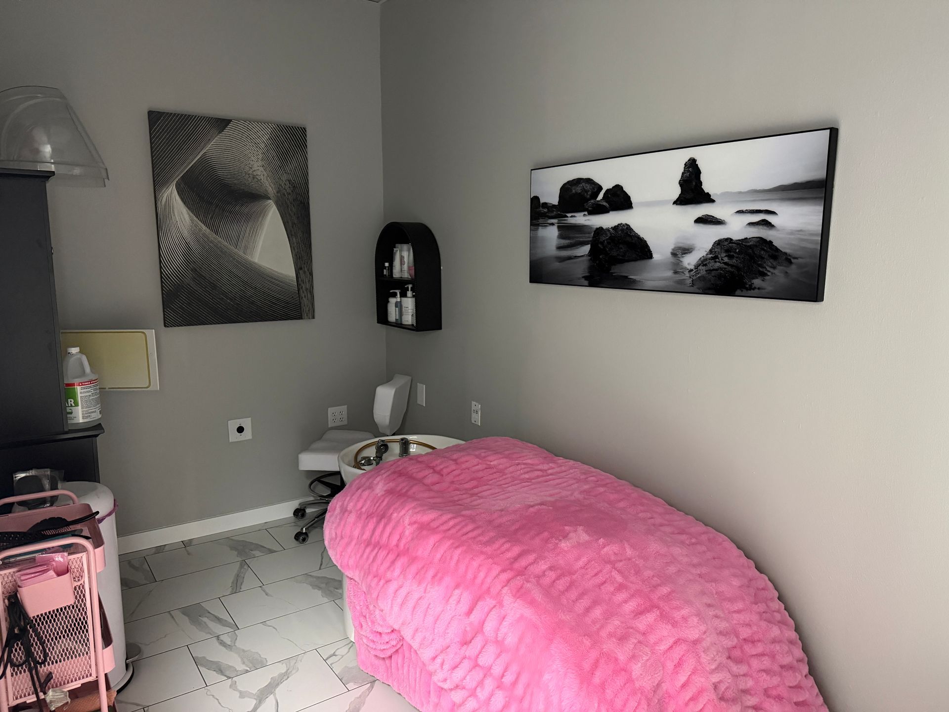 Person receiving a relaxing back massage on a white bed with soft spa lighting