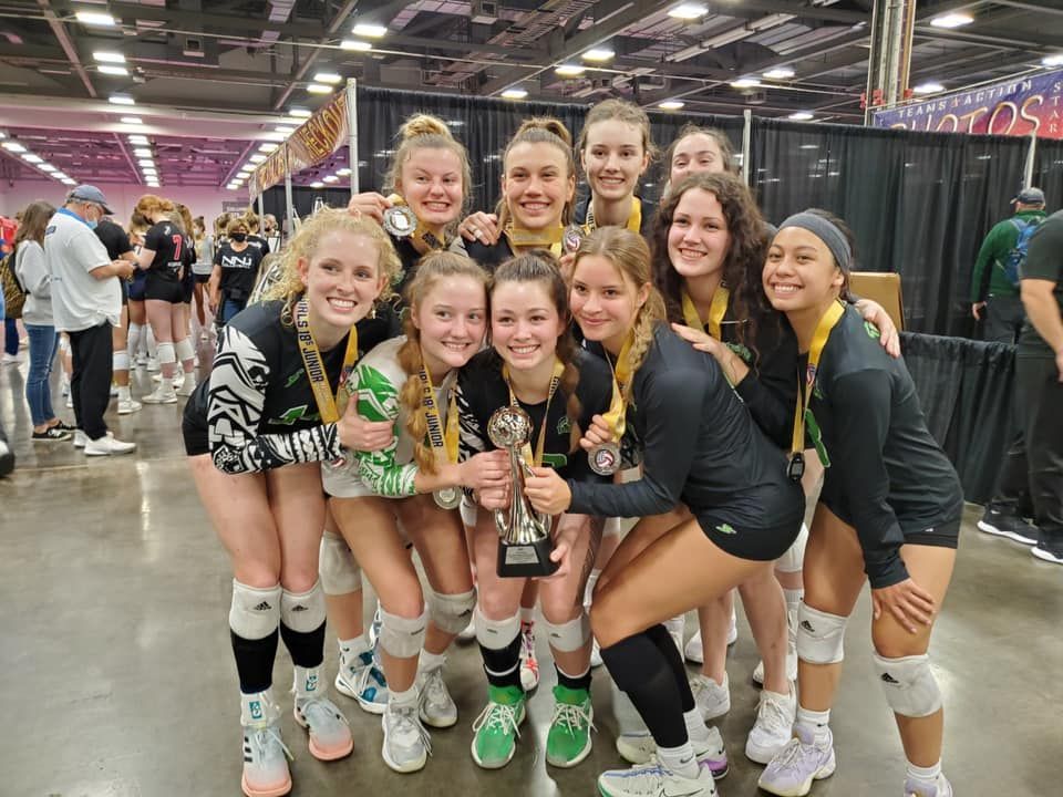 Pohaku Volleyball Club team smiling with a trophy and medals