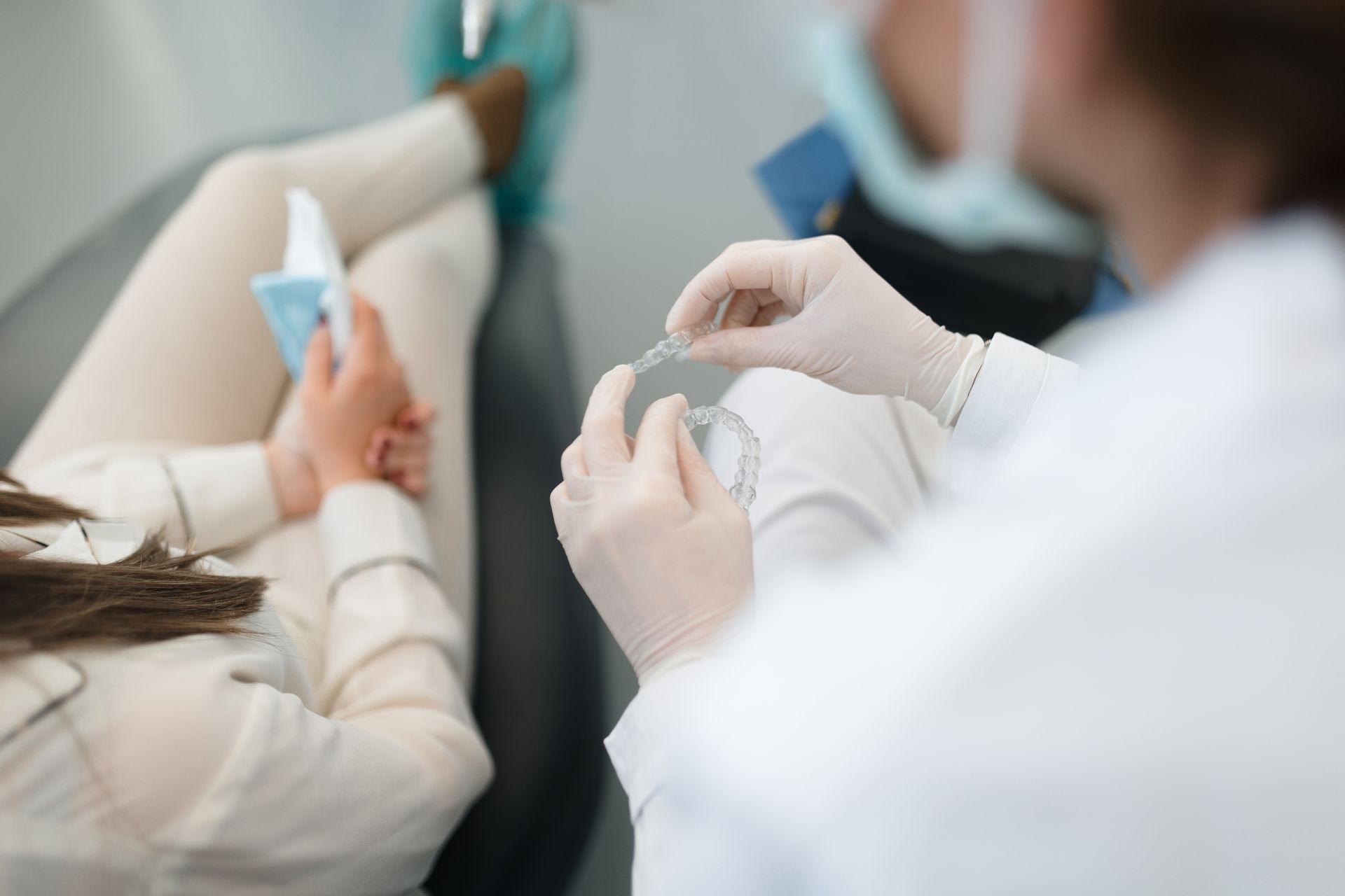 Healthcare worker administering an injection to a patient lying in a clinic bed