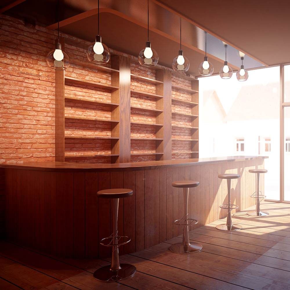 Empty brick-bar interior with hanging lights, wooden stools, and a sunlit counter